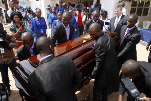 Pall bearers carry Achebe's casket to the hearse