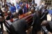 Pall bearers carry Achebe's casket to the hearse